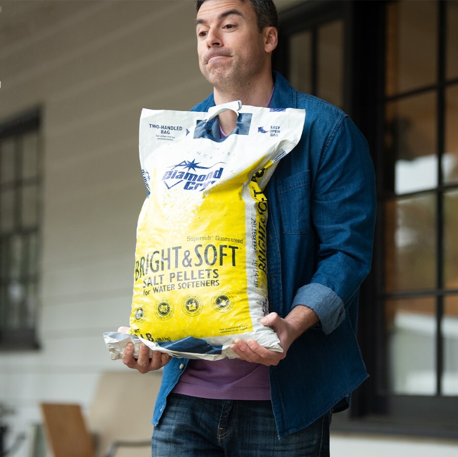 Man carrying heavy salt bag
